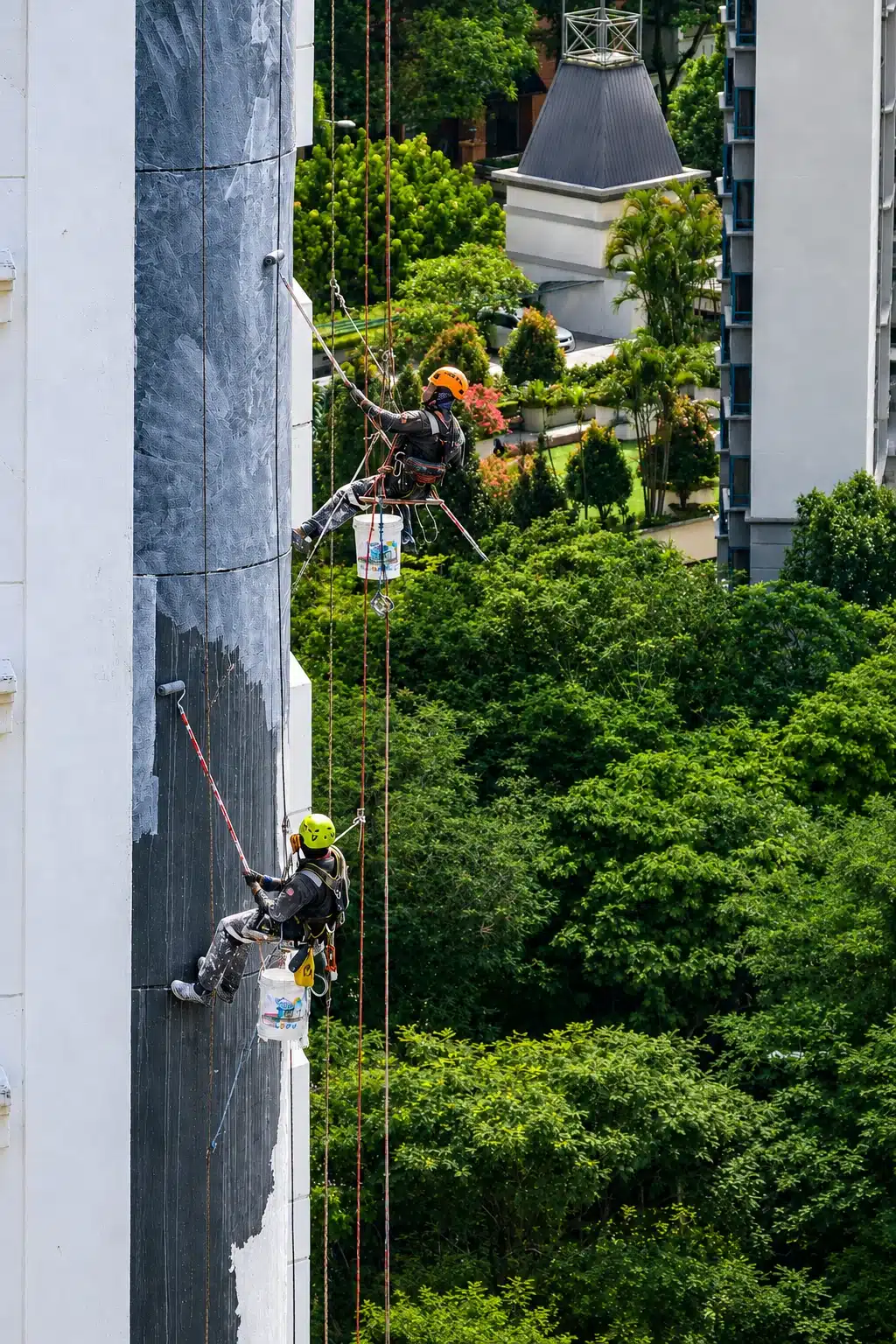 High-rise exterior painting by a rope access team